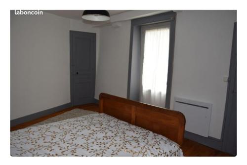 a bedroom with a bed and a window at Maison Terreaux in Vaux-en-Bugey
