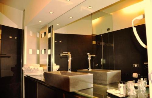 a bathroom with two sinks and a large mirror at Star Hotel Airport Verona in Dossobuono