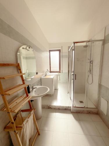 a bathroom with a shower and a sink and a mirror at B&B 31 mt dal Duomo in Benevento