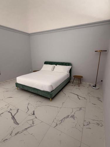 a bedroom with a bed and a marble floor at Vulcano Rooms 3 in Catania