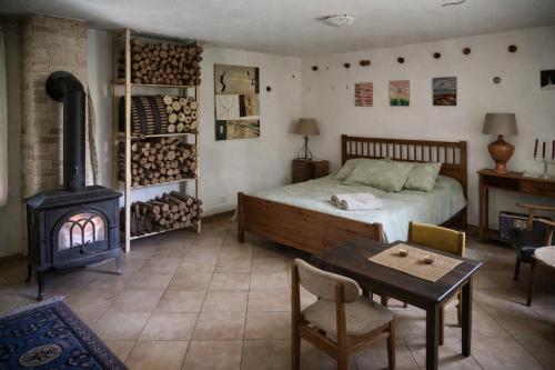 a bedroom with a bed and a wood stove at Dom w Przepitkach in Przepitki