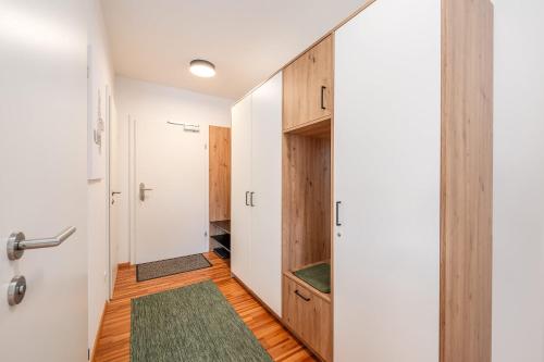 a room with a hallway with a door and a closet at Mountain Soulscape by myNests in Ennsling