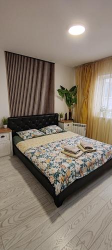 a bedroom with a bed with a comforter on it at Abel Luxury Home in Constanţa