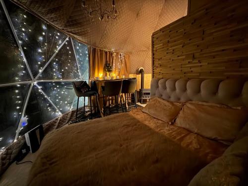 a bedroom with a large bed and a table at Infra Villa in Apšuciems