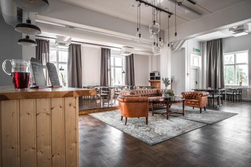 a living room with a couch and a table and chairs at Wärdshuset Liden in Liden