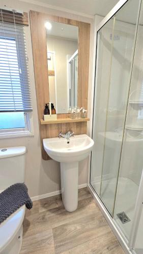 a bathroom with a sink and a shower at Cornwall Caravan Retreat 3 Crantock in Crantock