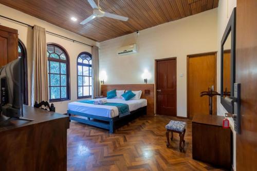 a bedroom with a bed and a tv in it at Bungalow 36 in Kandy