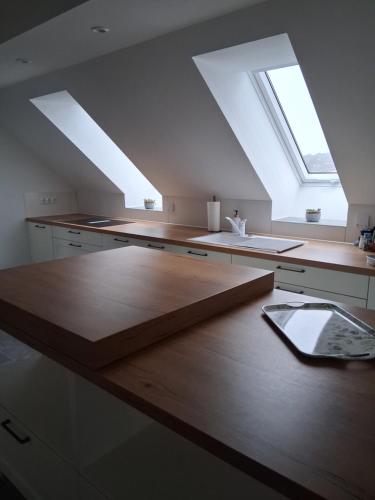 a kitchen with a wooden counter top with a skylight at Auszeit in Storkow