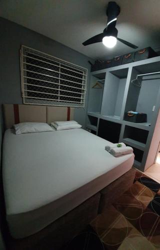 a bedroom with a white bed with a ceiling fan at Bedroom Airport in Maceió