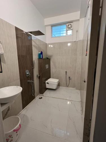 a bathroom with a toilet and a sink at Pappu in Siliguri
