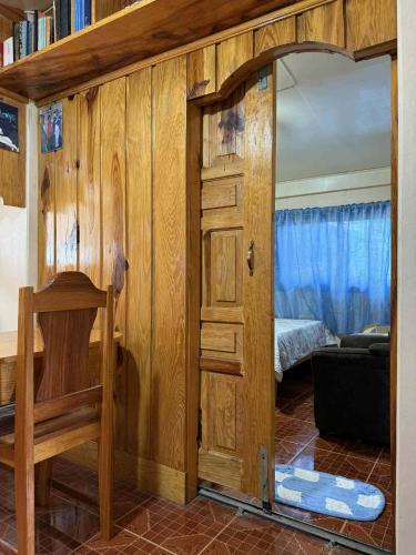 a room with a wooden door and a bedroom at RD's Apartment in Eyeb, Poblacion, Bontoc in Bontoc