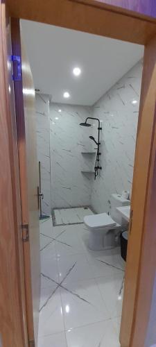 a bathroom with a toilet and a sink at Maghrib ARABI OULED OUJIH in Kenitra