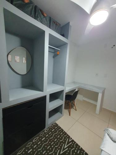 a bedroom with a desk and a mirror and a bed at Bedroom Airport in Maceió