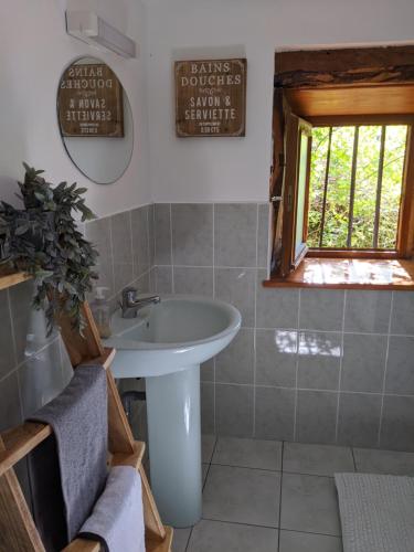 a bathroom with a sink and a window at Cottage in Auvergne in Laval-sur-Doulon