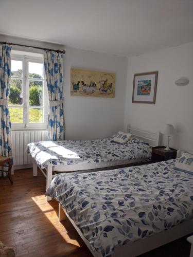 a bedroom with two beds and a window at Cottage in Auvergne in Laval-sur-Doulon