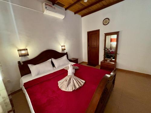 a bedroom with a bed with a dress on it at Sonic Villa,Beruwala in Beruwala
