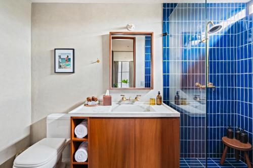 a bathroom with a sink and a toilet and a shower at ALMA Surf Lodge in Punta Mita