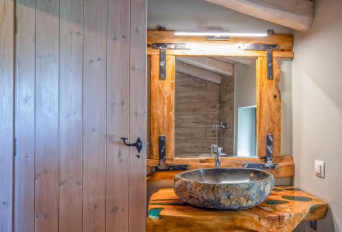 a bathroom with a stone sink and a mirror at Villa Dias by Elayan Villas Corfu in Karousádes