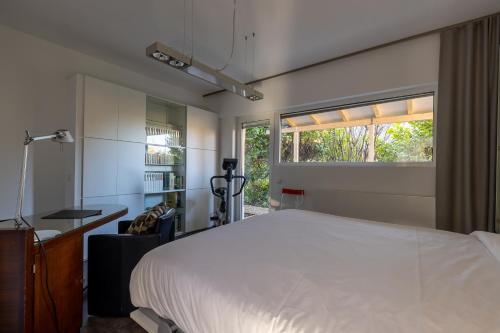 a bedroom with a large white bed and a window at Home sweet Lux - 8P - House & garden - 280n m2 in Lorentzweiler