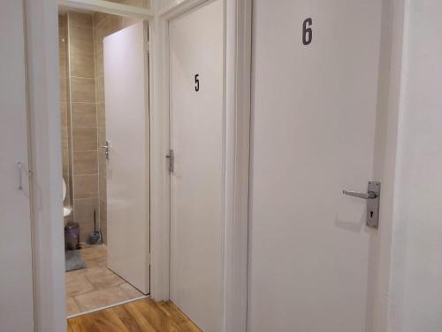 a bathroom with a toilet and a door with numbers on it at Maxismile Haven in Southend-on-Sea