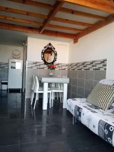 a kitchen and dining room with a table and chairs at Maison cosy Santa Barbara in Le Barcarès