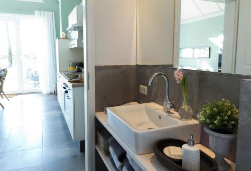 a kitchen with a white sink and a counter at Ferienhaus Clara in Wardenburg