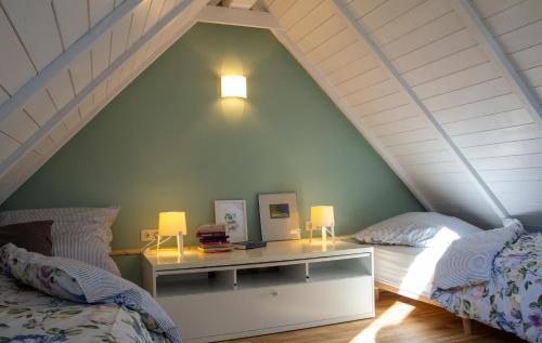 a bedroom with two beds and a desk with two lamps at Ferienhaus Clara in Wardenburg