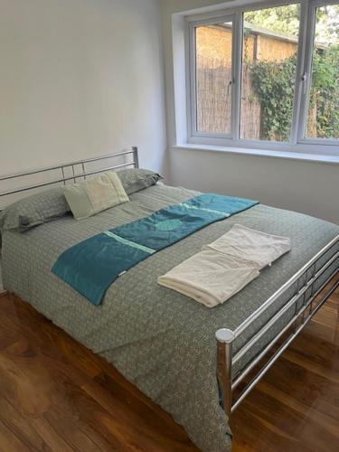 a large bed in a room with a window at Maxismile Haven in Southend-on-Sea