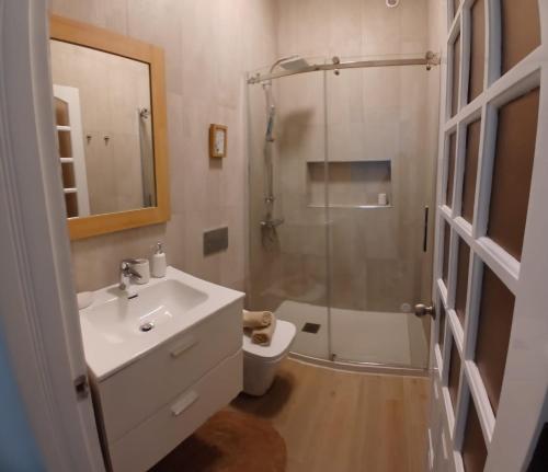a bathroom with a sink and a shower and a toilet at Avenida Dr Baltazar Lopes da Silva 33A in Mindelo