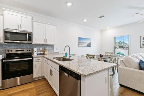 a kitchen with white cabinets and a counter top at Family home near boat launches, beaches, and The Wharf! King bed and pet friendly in Orange Beach