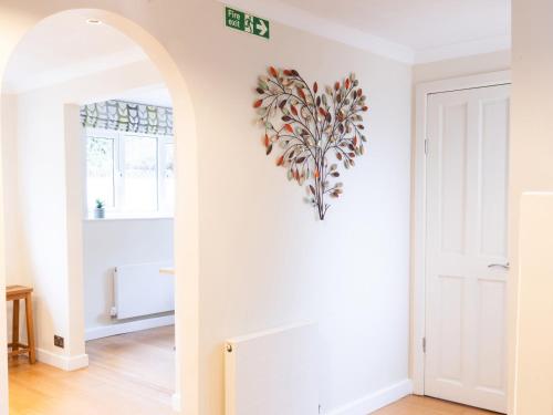 a heart shaped wall art on a white wall in a room at White Stones in Burford