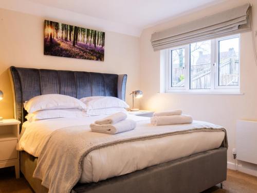 a bedroom with a large bed with towels on it at White Stones in Burford