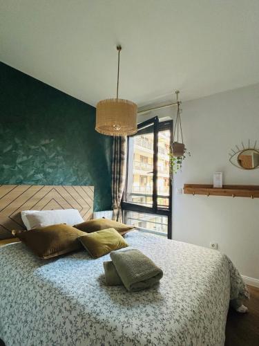 a bedroom with a bed with pillows on it at Les Chambres de David in Paris