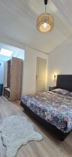a bedroom with a bed and a rug on the floor at Au calme, parking gratuit,proche centre Thonon les bains in Allinges