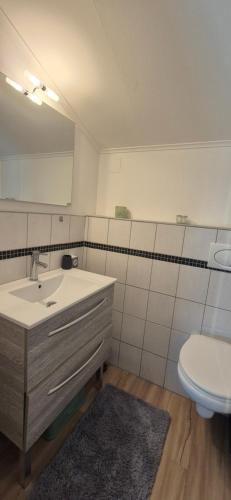 a bathroom with a sink and a toilet at Au calme, parking gratuit,proche centre Thonon les bains in Allinges