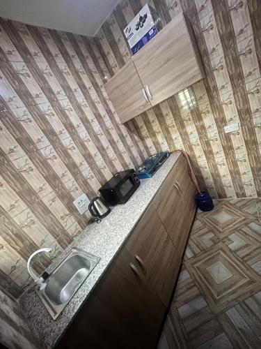 a small kitchen with a sink and a counter at GAO-Apartments in Egbelu