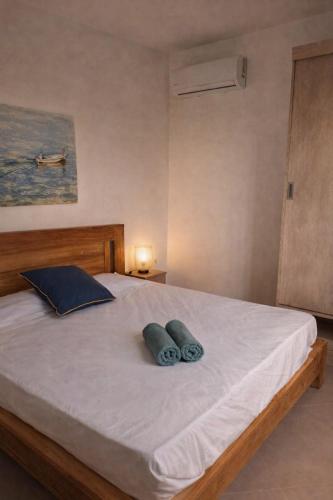 a bedroom with a bed with two pillows on it at Sunset Haven in Flic-en-Flac