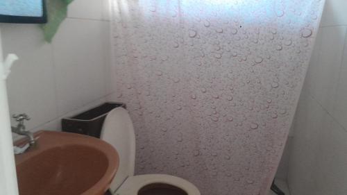 a bathroom with a toilet and a sink at Casa de adao in Guarujá