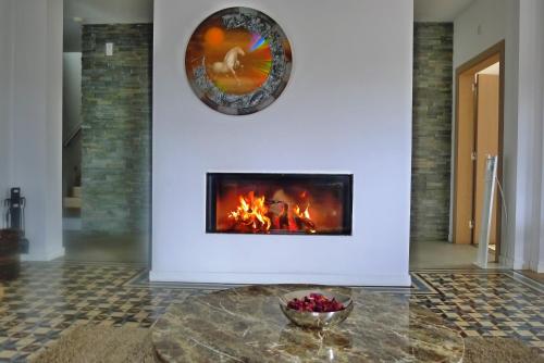 a fireplace in a living room with a table at Quinta das Lavandas in Castelo de Vide