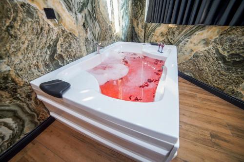 a bath tub filled with water in a room at Dual Hotel Halkalı in Istanbul