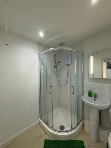 a bathroom with a shower and a sink at Studio with Parking & Shops at Your Door in Andover