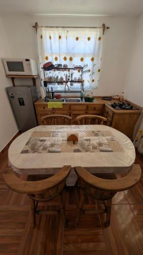 a kitchen with a table with chairs and a window at Casa Rancho El Capulín en Grutas de Tolantongo