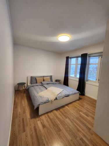 a bedroom with a bed and a wooden floor at Kalveld aparment 2 in Lillesand