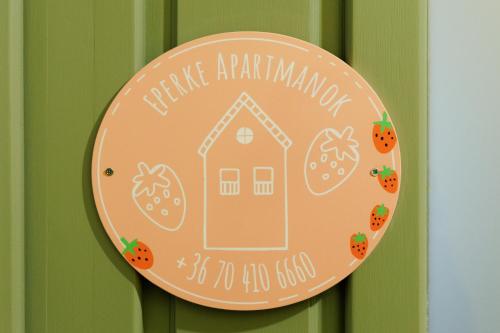 a sign on a door with a house on it at Eperke Apartmanok in Balatonfüred