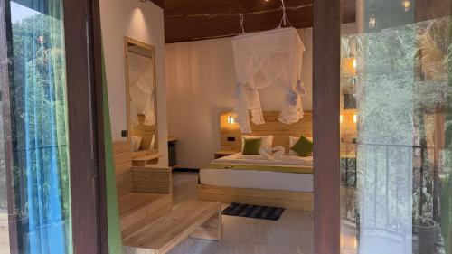 a bedroom with a bed in a room with a window at Rawana River Edge in Ella