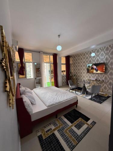 a bedroom with a bed and a living room at Bright Dakar Plateau Apartment in Dakar
