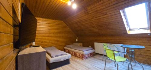 a room with a bed and a table in a cabin at Villa MarViK in Lučenec