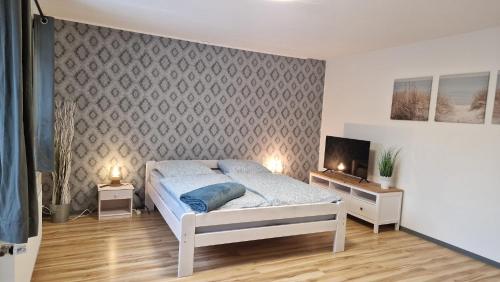a bedroom with a bed and a tv in it at Ferienwohnung Dons in Grömitz
