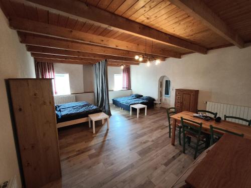 a living room with two beds and a table at Apartment Le 1739 in La Coste