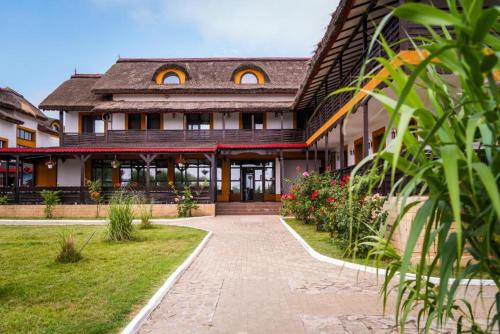 a building with a pathway in front of it at Danubiu Resort in Murighiol